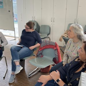 Group of female professionals participating in a workshop session.